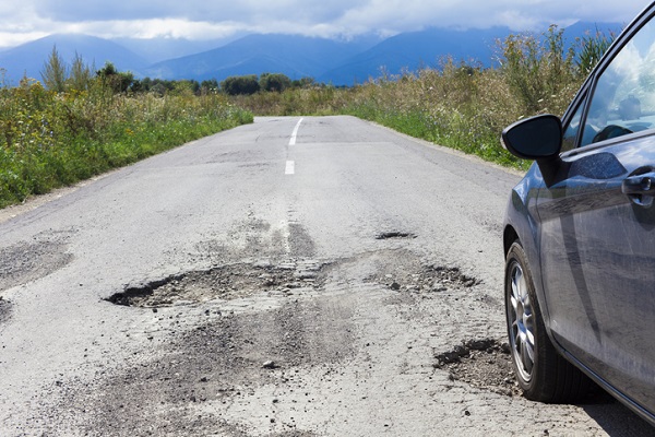 Car owners benefit from cautious driving, including slowing down over potholes