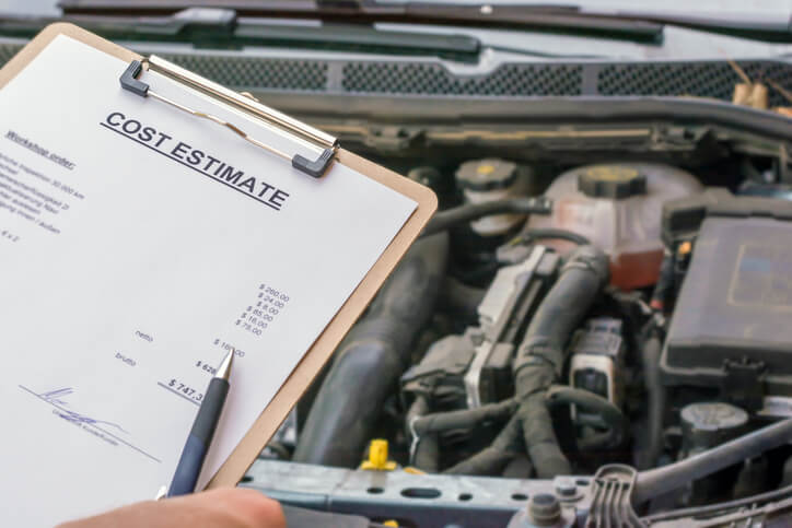 A hand drafting invoices after auto mechanic school