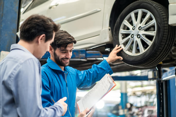 Student in auto parts training explaining maintenance process to a client