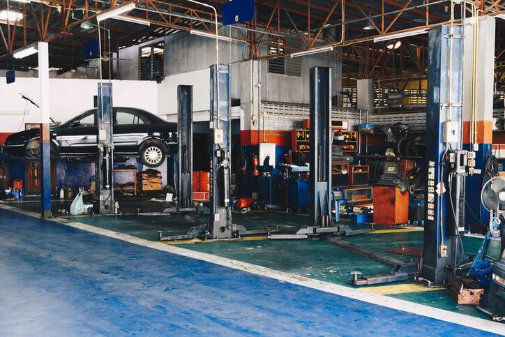 Auto mechanic training graduate inspecting and fixing a truck engine