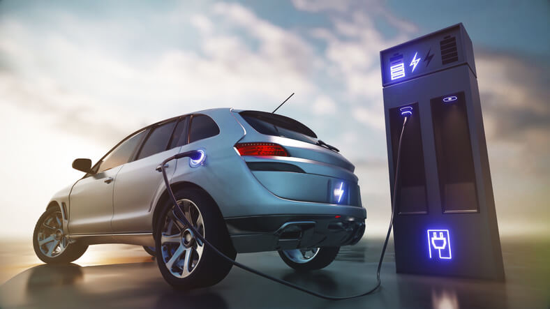 An electric vehicle connected to a charger in automotive school