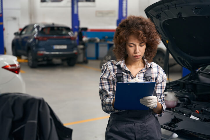 A female service writer at an auto repair shop after service advisor training