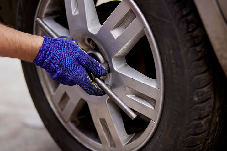 Professional tire installer changing a vehicle's tires after automotive technology training
