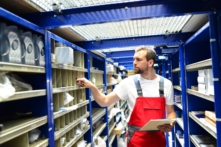 An auto part technician retrieving an item in the warehouse after auto parts training.