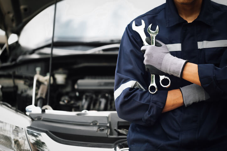 A male auto mechanic working on a vehicle after hybrid and electrical mechanic training