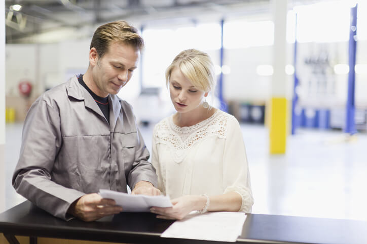 A male auto service advisor communicating with a female customer after his auto sales training