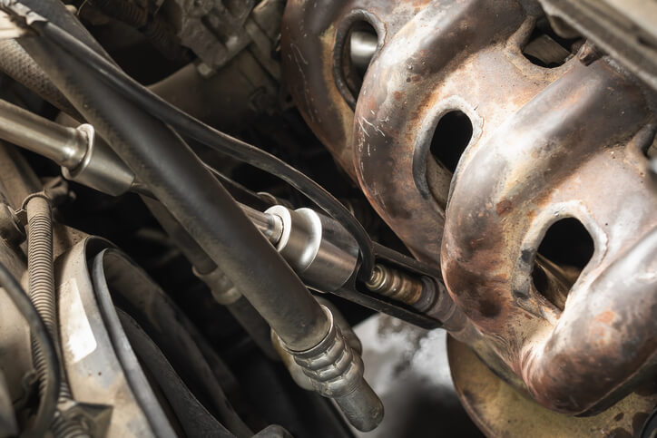 An oxygen sensor screwed on a car engine in automotive service technician training