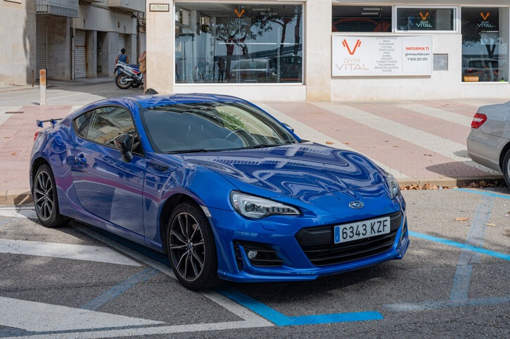 A parked Blue 2024 Subaru BRZ in auto mechanic school