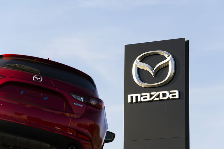 An auto mechanic visiting a Mazda showroom