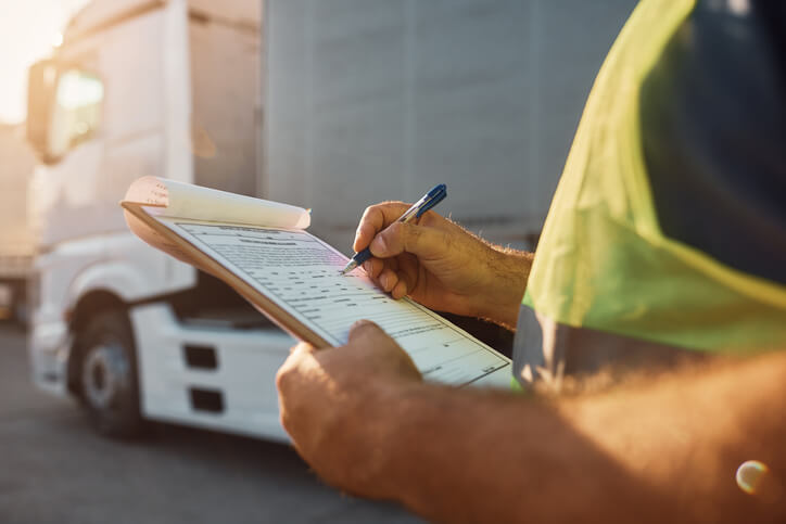 A male dispatch training grad going through a checklist