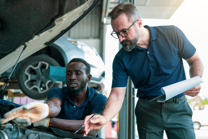 A service advisor explaining technical issues and maintenance plans