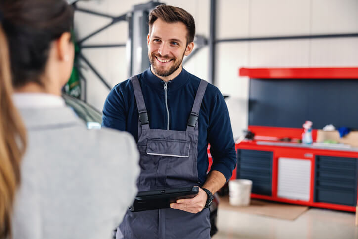 An auto parts training grad interacting with a client