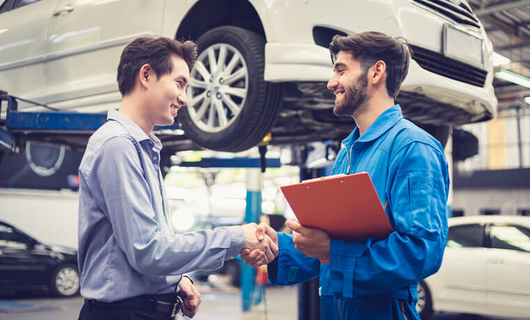 An automotive service advisor interacting with a customer after completing his service advisor training