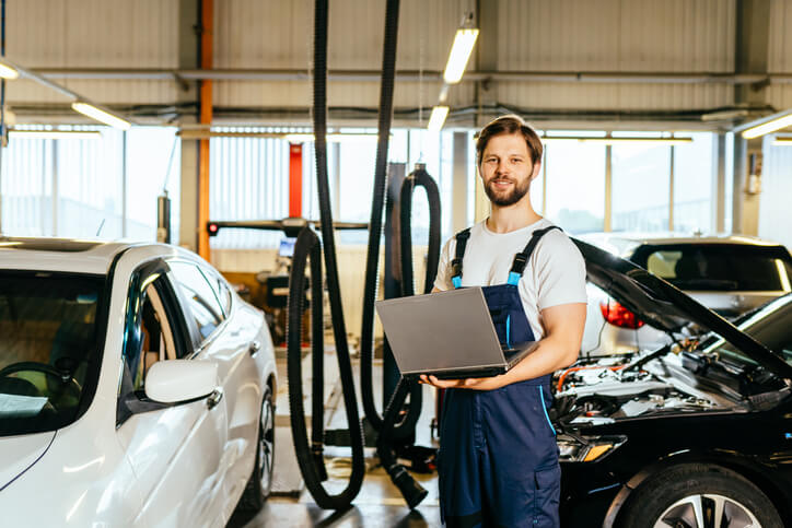 An automotive training grad working on a laptop