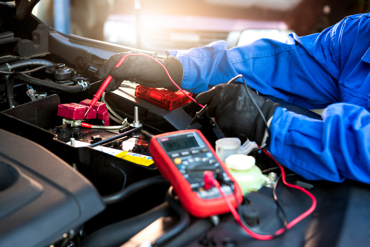 Electrical specialist working on an EV after completing his auto mechanic training