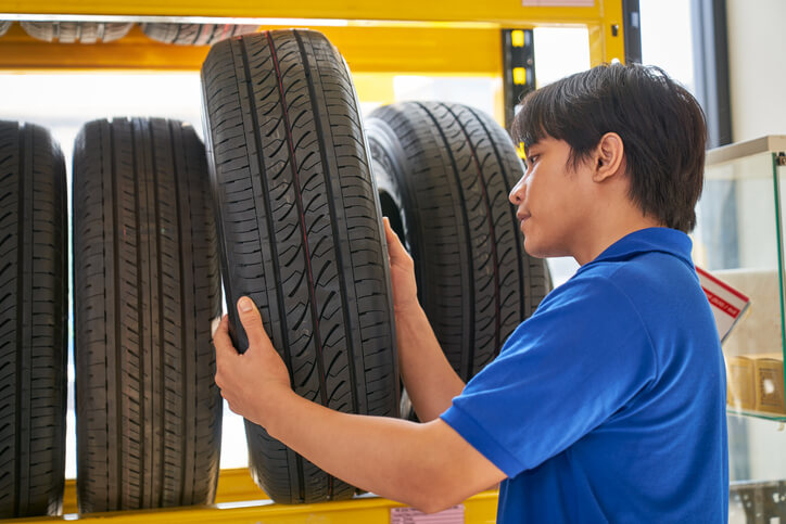 A male auto parts store manager checking inventory after completing his auto parts training