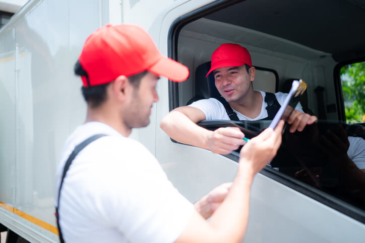 A male dispatcher interacting with a truck driver after completing his dispatch training