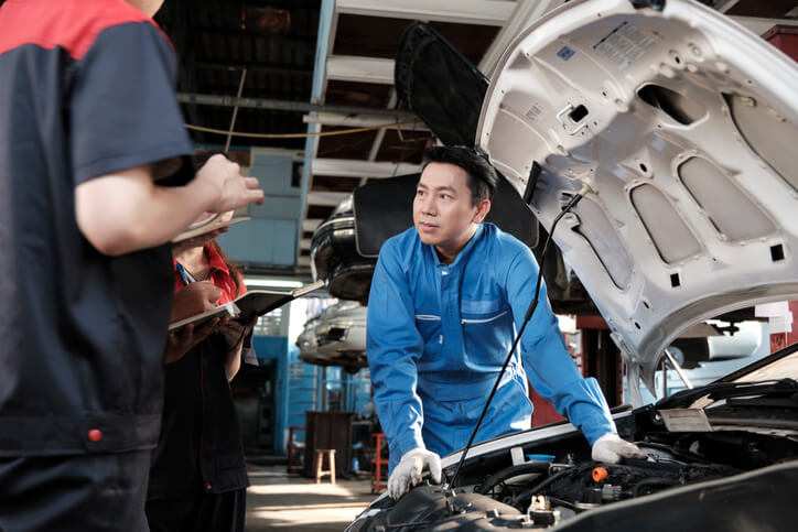 An instructor demonstrating engine vibration analysis in a training lab