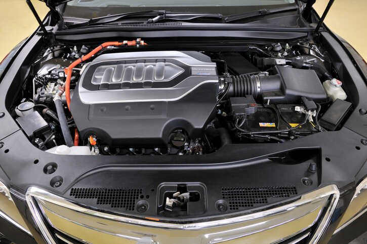 An auto mechanic school student working on a 48V hybrid vehicle