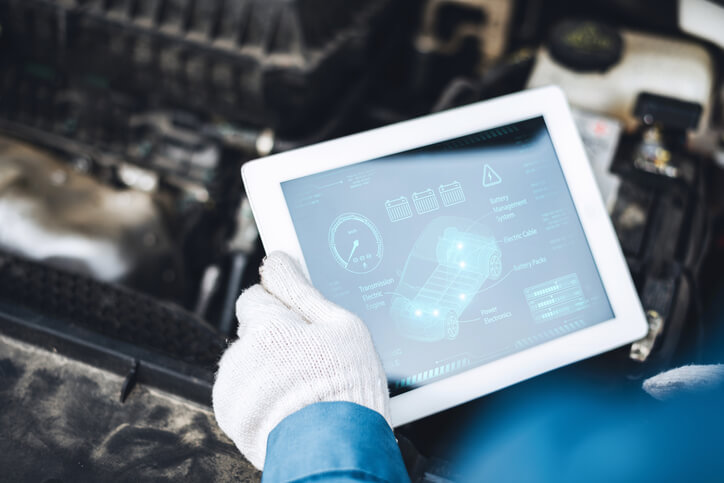 A technician reviewing vehicle data from a telematics interface