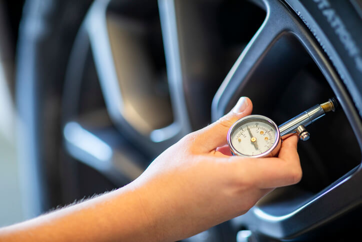 A student at ATC Surrey checking tire pressure during training