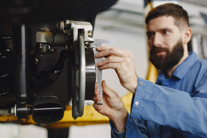 An auto mechanic student analyzing the EV brake system