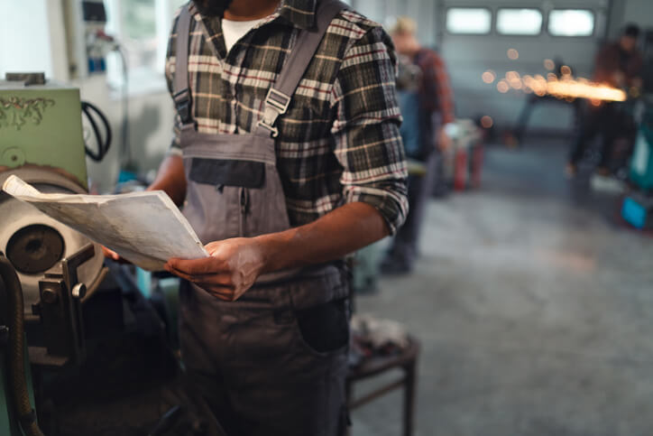 An automotive training student examining a service bulletin