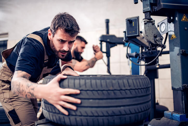 An automotive training student learning tire balancing techniques