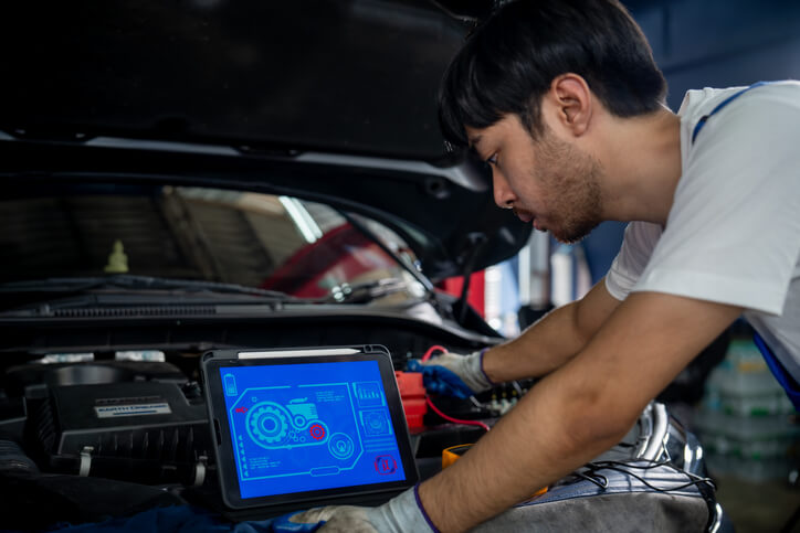 An automotive technician diagnosing transmission issues in the shop