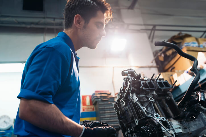 An auto mechanic student examining a CVT system