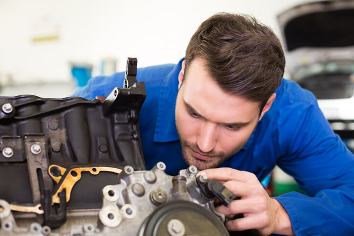 An ATC student working on a vehicle engine