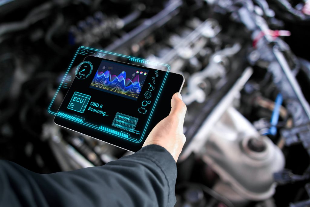 An auto technician using AI diagnostics on a vehicle