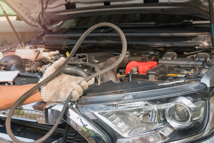An instructor demonstrating timing belt replacement during automotive training