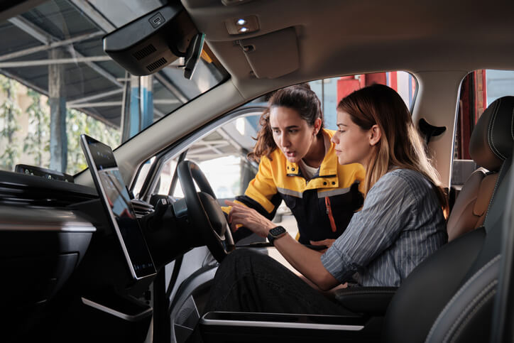 An AST student at auto mechanic school practicing communication skills