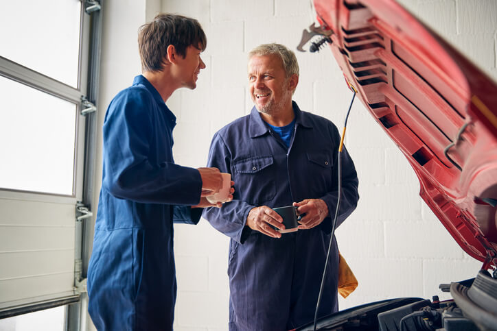 An instructor teaching auto mechanic students about key programming