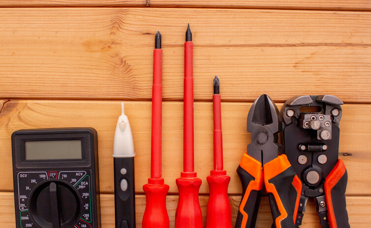Various insulated tools used by a hybrid and electrical mechanic during electric vehicle (EV) auto repair