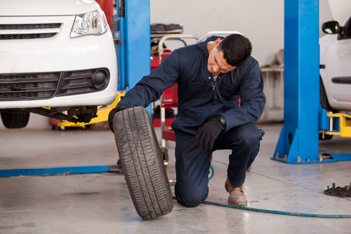 A student learning tire technology in auto mechanic training