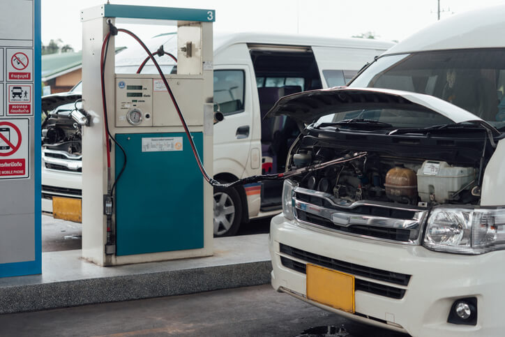 A combustion engine car at a repair shop receiving eco-friendly fuel