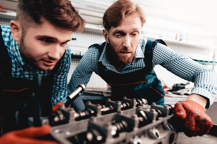 Auto mechanic student learning about AWD system components
