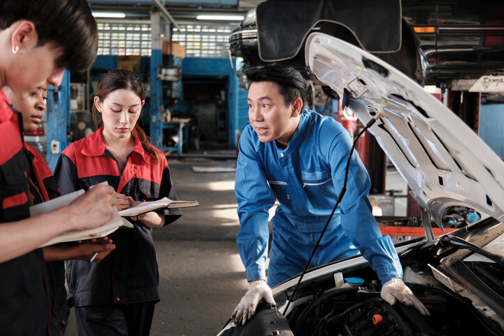 A student learning about recycled auto parts in a training class