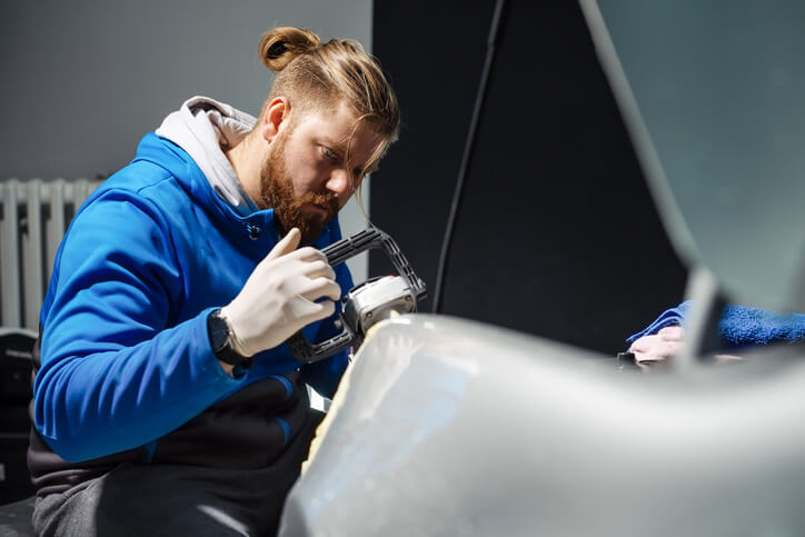 An instructor teaching composite body repair in auto body class