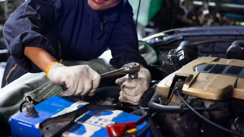 A Mechanic working on a car engine during an automotive training session