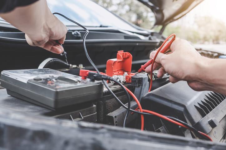 A technician inspecting an EV battery in winter