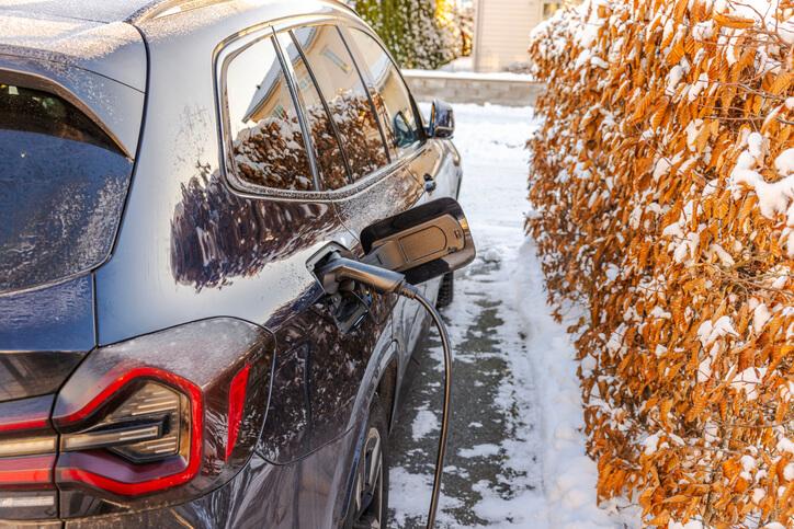 An e; electric vehicle parked on a snowy Montreal street