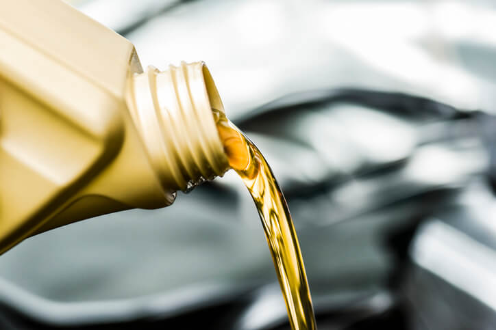An automotive training Montreal student checking winter engine oil