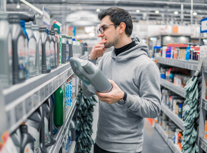 auto mechanic school: technician comparing synthetic and conventional oil samples