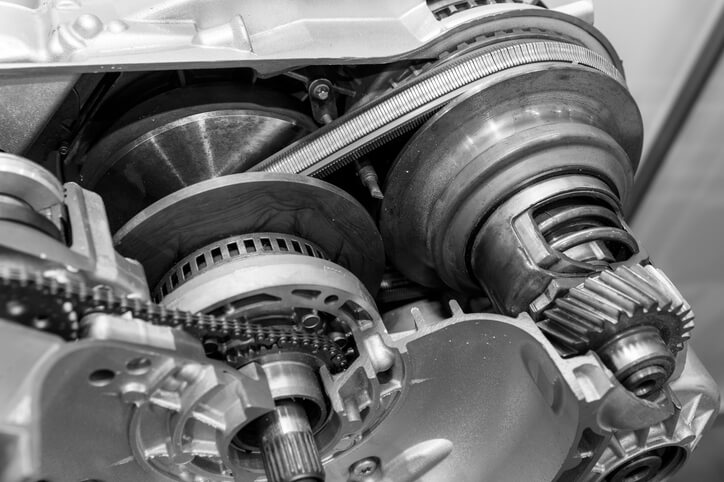 A close-up view of a CVT transmission cutaway, showing pulleys and a metal belt used in modern auto mechanic training.