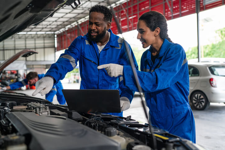 A group of automotive school students practicing EV repair and diagnostics in BC