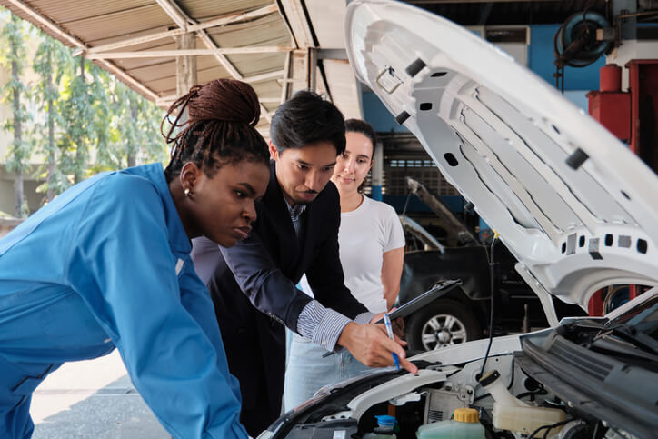 A pair of ATC Montreal students working on vehicle electrical systems, while undergoing automotive training in Montreal.
