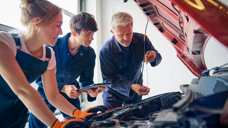 A student working with diagnostic tools during auto mechanic school in Surrey
